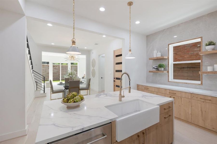 The porcelain farmhouse sink is a beautiful accent in this chef's kitchen.