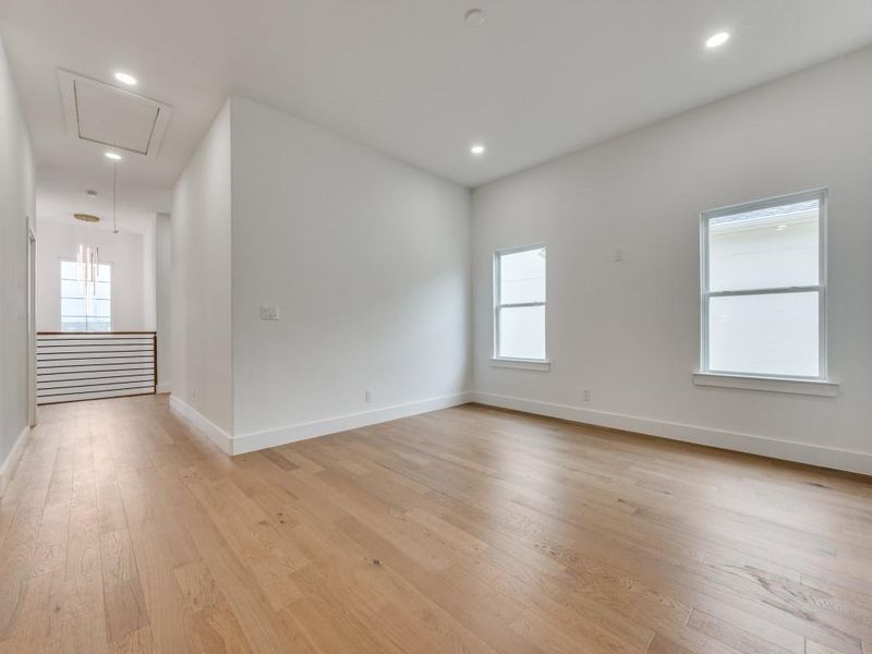 Spare room featuring light hardwood / wood-style floors and a healthy amount of sunlight