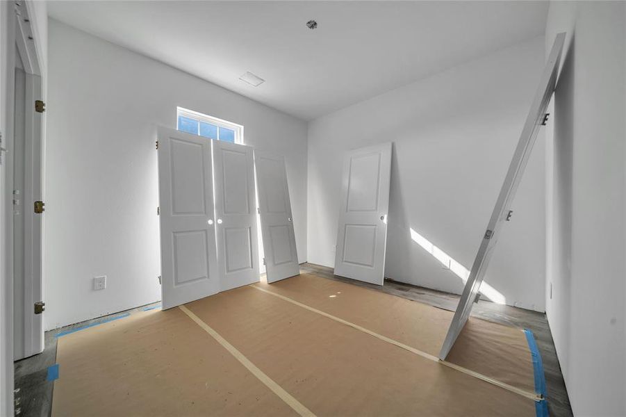 Unfurnished bedroom with wood-type flooring and a closet