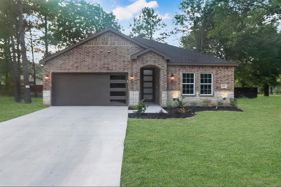 View of front facade with a garage and a front yard