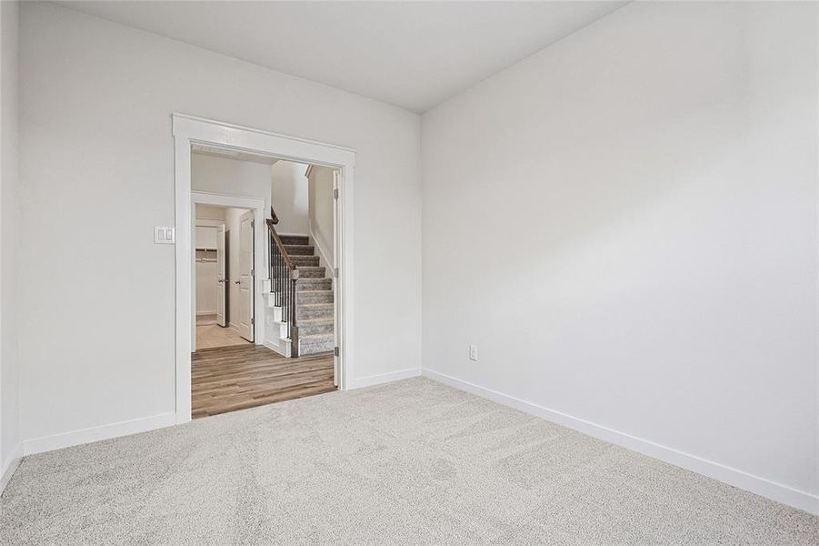 Empty room featuring light colored carpet