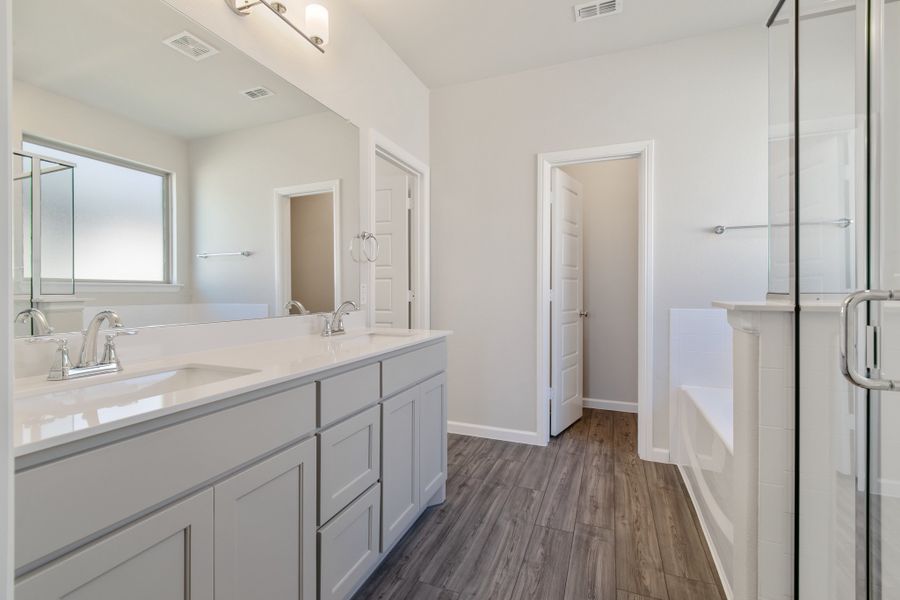 Primary bathroom in the Masters home plan by Trophy Signature Homes – REPRESENTATIVE PHOTO