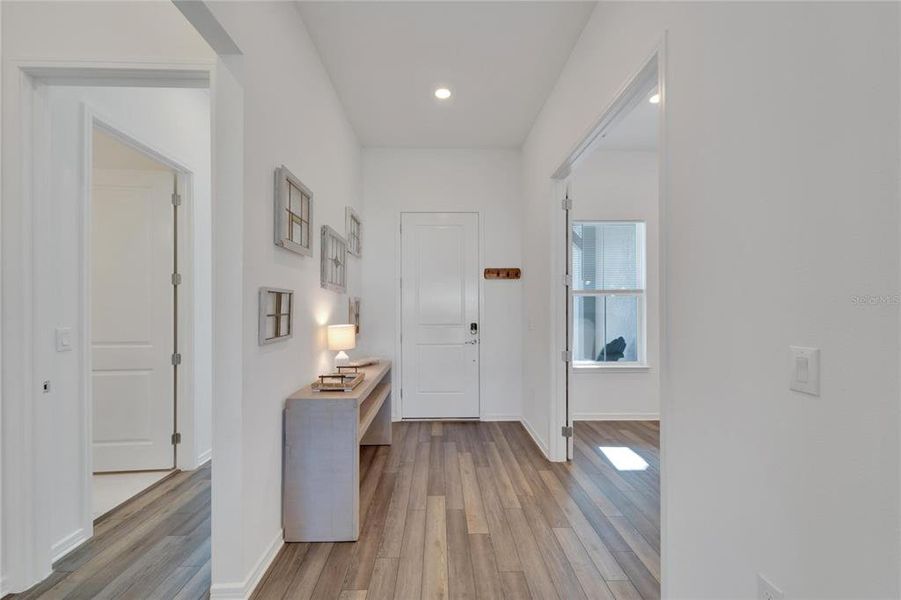 back to foyer with double door office and hallway leading to in-law/ guest suite