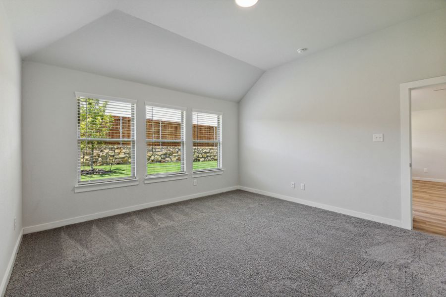 Primary bedroom in the Quartz home plan by Trophy Signature Homes – REPRESENTATIVE PHOTO