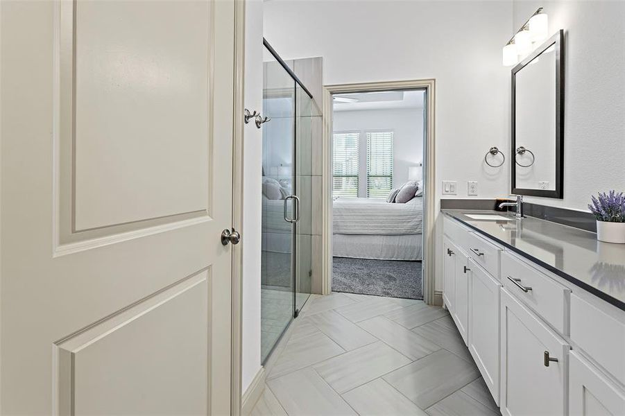 Bathroom featuring walk in shower and vanity