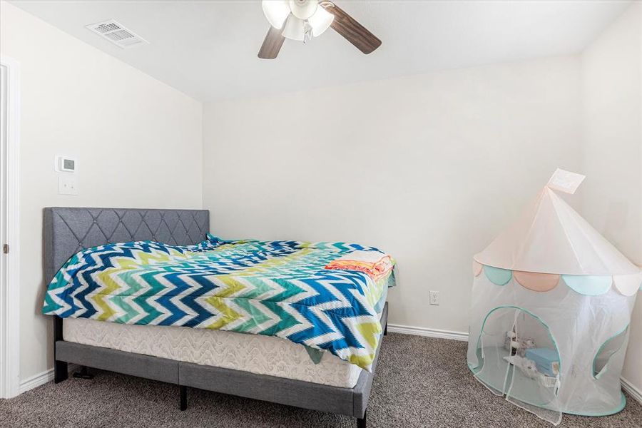 Bedroom featuring carpet flooring and ceiling fan