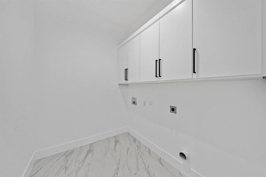 Laundry room featuring cabinets, hookup for a gas dryer, washer hookup, and electric dryer hookup