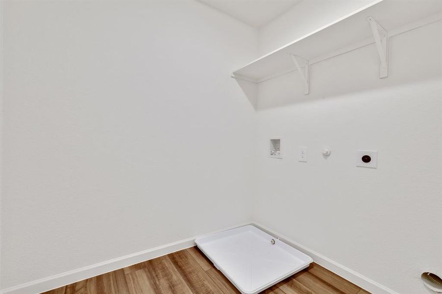 Laundry room featuring hookup for an electric dryer, hookup for a gas dryer, hardwood / wood-style flooring, and hookup for a washing machine