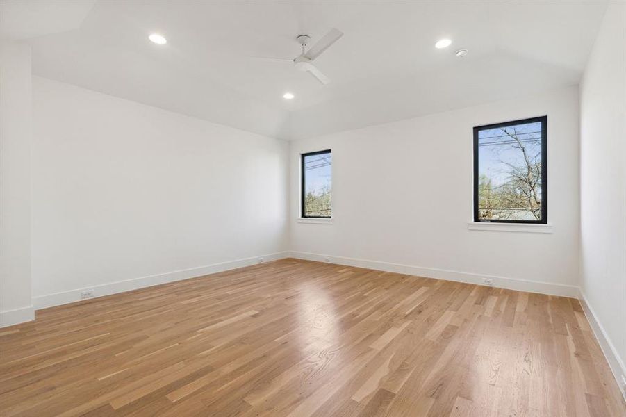 Secondary bedroom featuring light wood and a ceiling fan