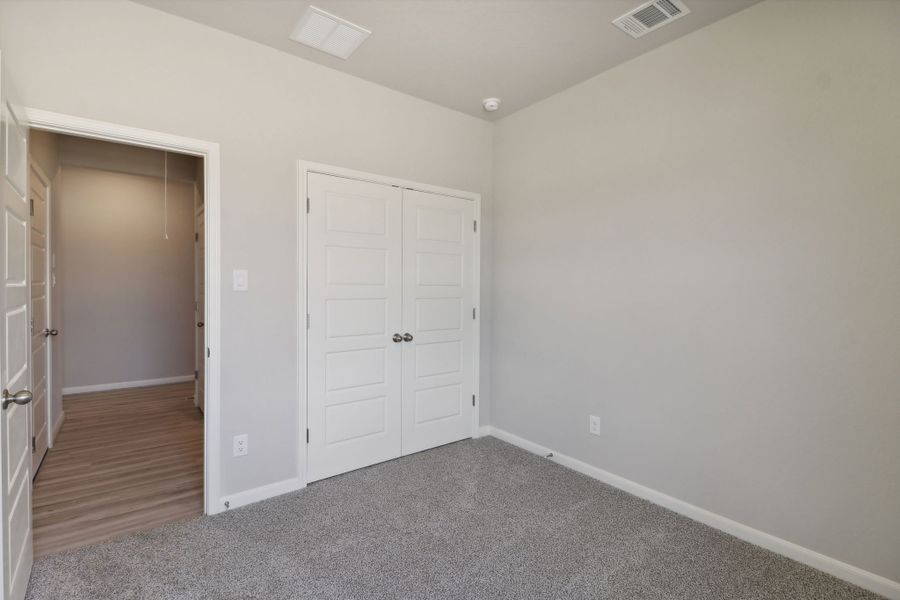 Guest bedroom in the Callaghan floorplan at a Meritage Homes community.