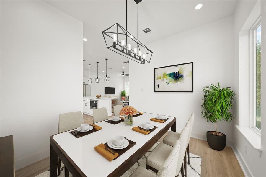 Virtually Staged: The dining room has direct access to the kitchen, and living space. Photos are from a similar unit in the development.