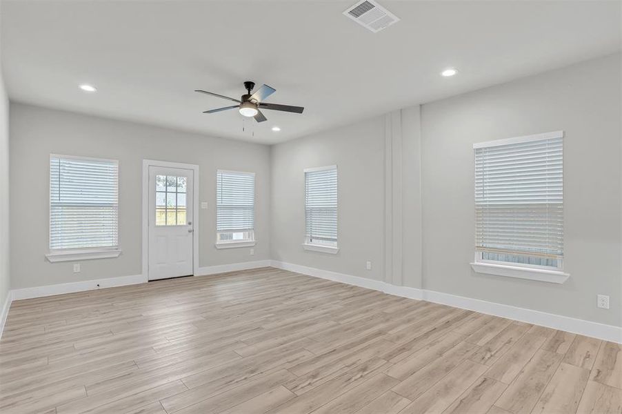 Spare room with light wood-type flooring and ceiling fan