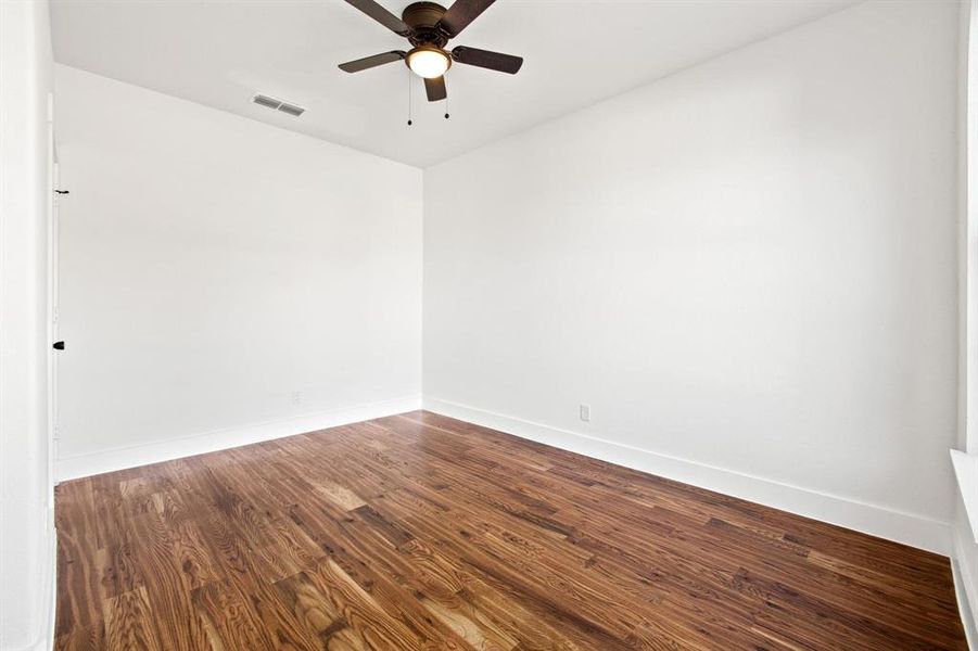 Unfurnished room with hardwood / wood-style floors and ceiling fan