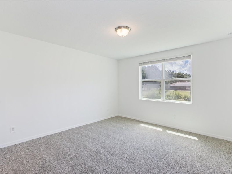 Primary bedroom in the Foxglove floorplan at 5166 Minneola Lane