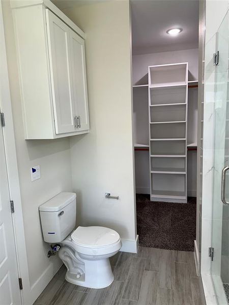 Bathroom with a shower with door and toilet