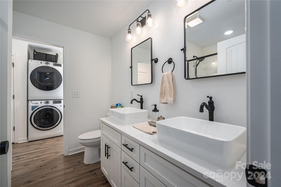 Primary bath, double sink, second exit leads to laundry room