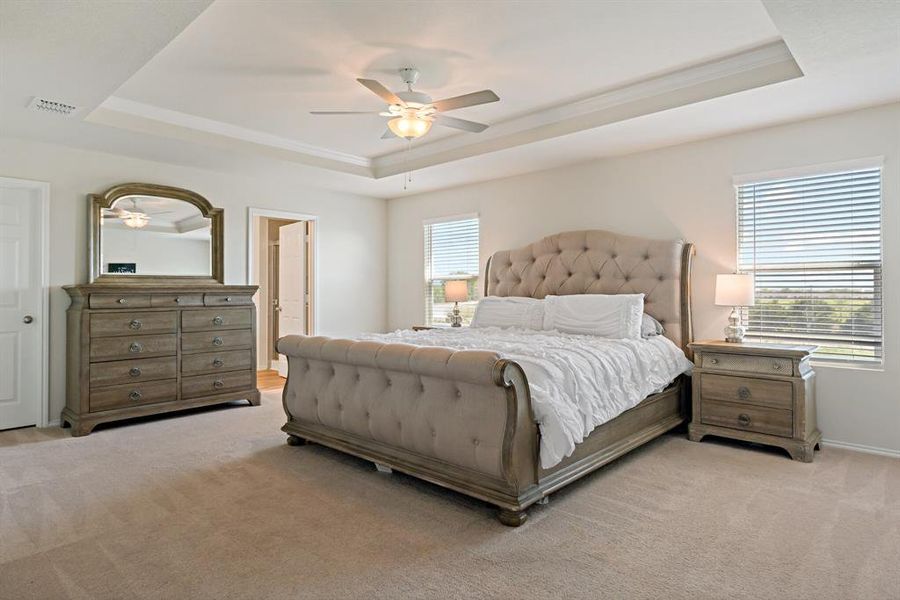 The elegant primary retreat is spacious enough to comfortably fit a king-sized bed with plenty of room to spare.