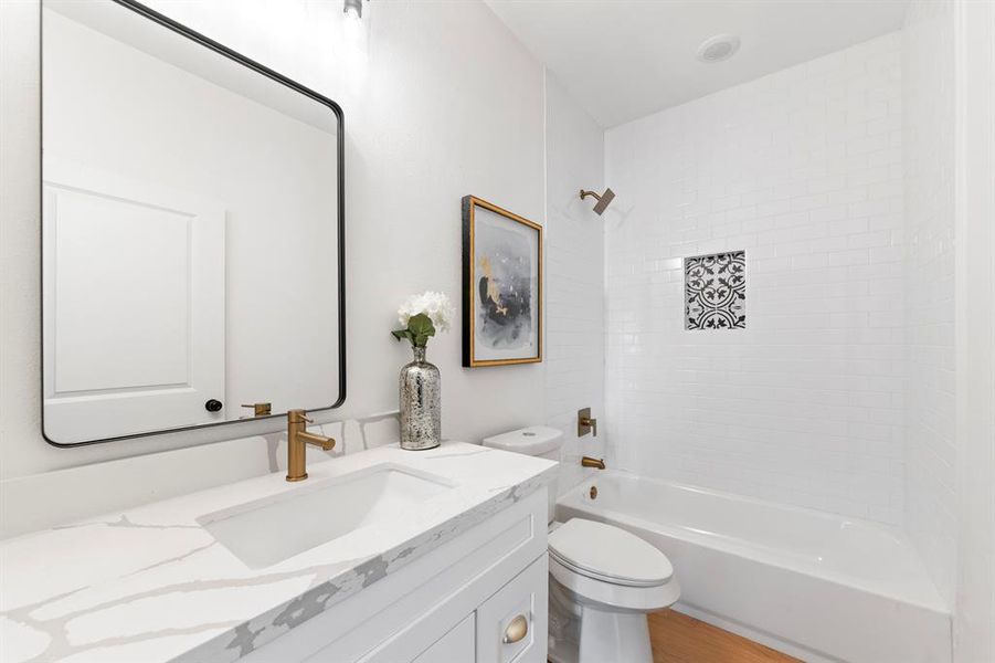 Full bath using the same tile and easy clean up engineered floors throughout.