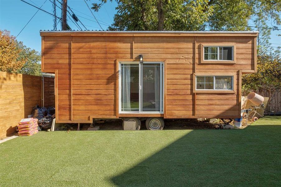 The modern tiny home offers versatile living options, serving as guest accommodations or a potential rental income source.