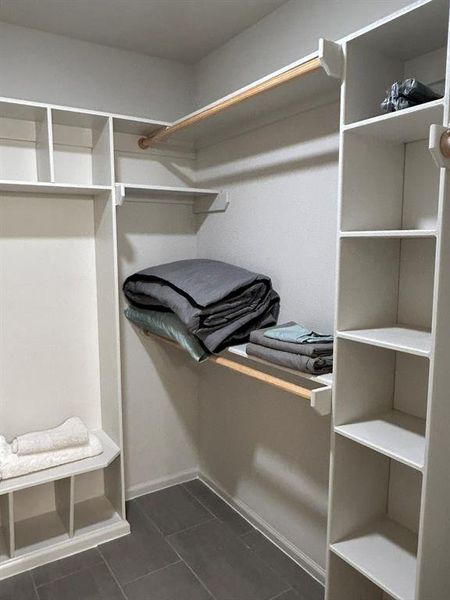 Spacious closet featuring dark tile patterned floors