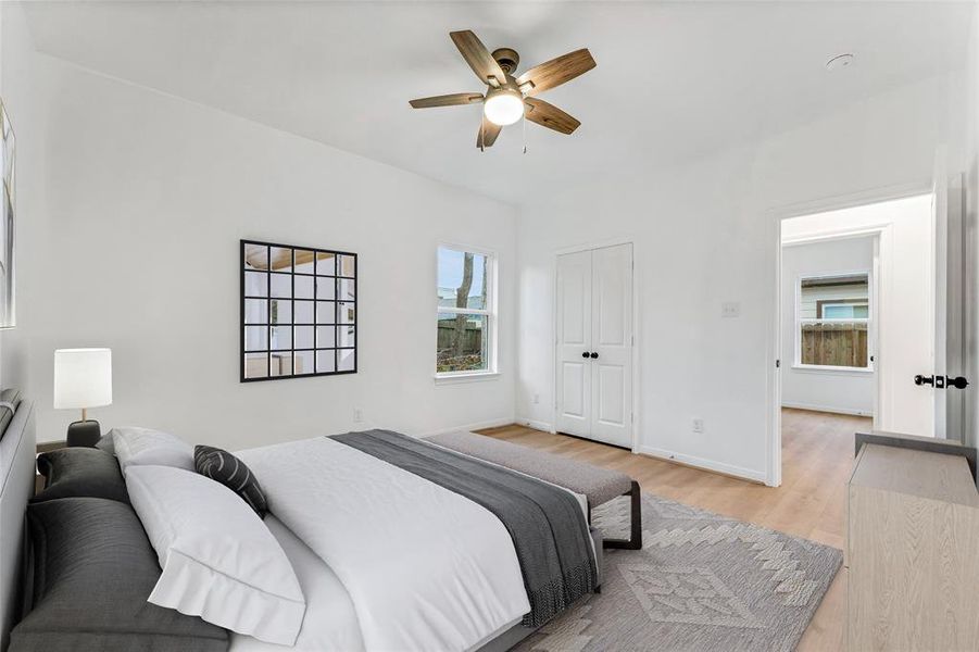 The entry to the master bathroom offers a tantalizing preview of the relaxing oasis that awaits, complete with a spacious closet. (Virtual Staging May Be Present)