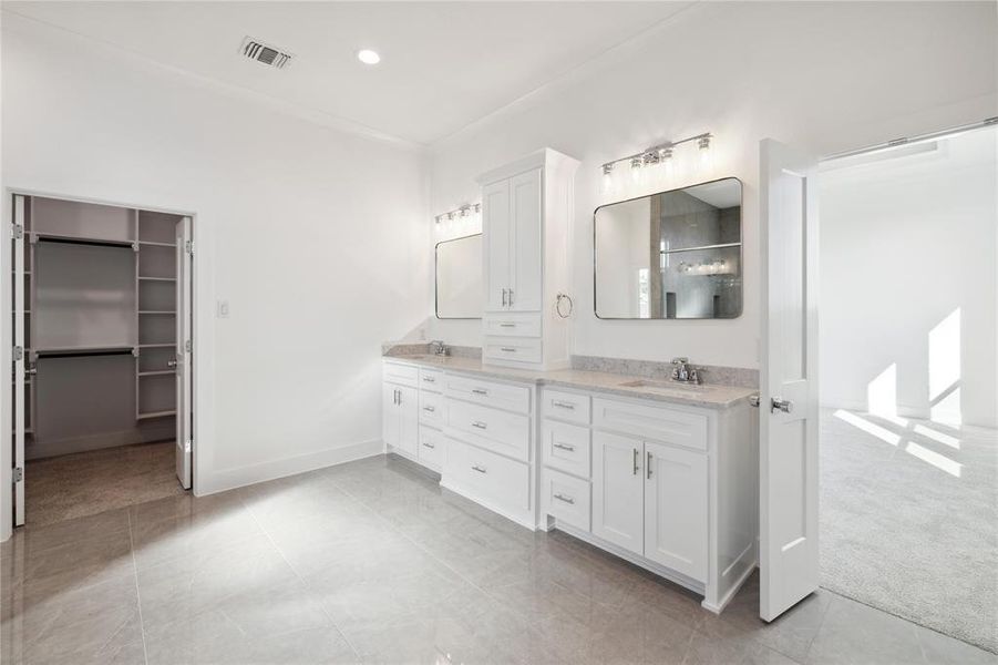 Bathroom featuring vanity and a shower with shower door