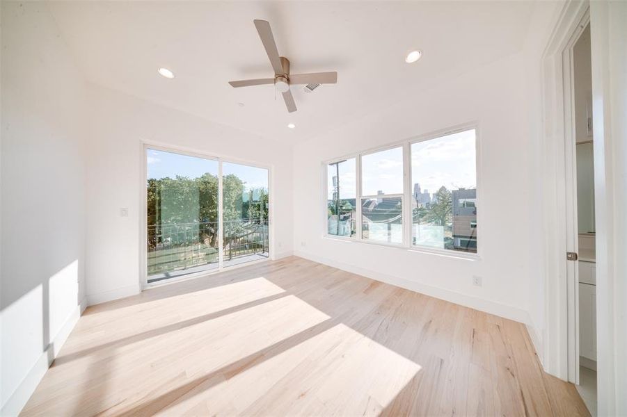 Empty room with light hardwood / wood-style flooring and ceiling fan