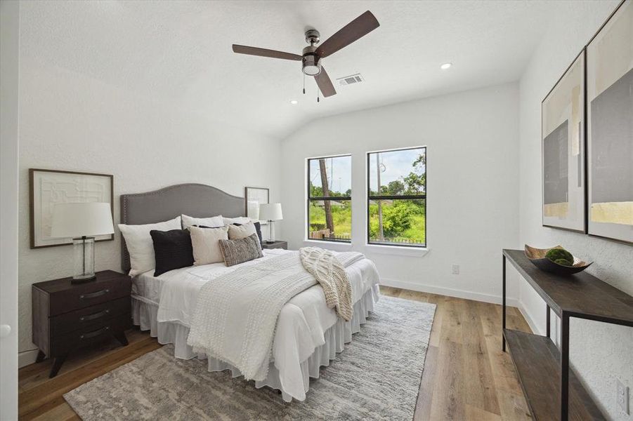 Guests will feel right at home in this spacious bedroom. This spacious bedroom offers luxurious vinyl plank flooring, neutral paint, a modern ceiling fan, a large closet and easy access to a full bathroom.