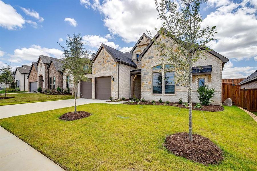 View of front of home featuring a garage and a front lawn