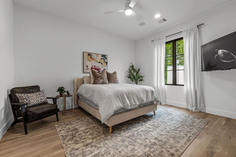 Bedroom with ceiling fan and light hardwood / wood-style floors