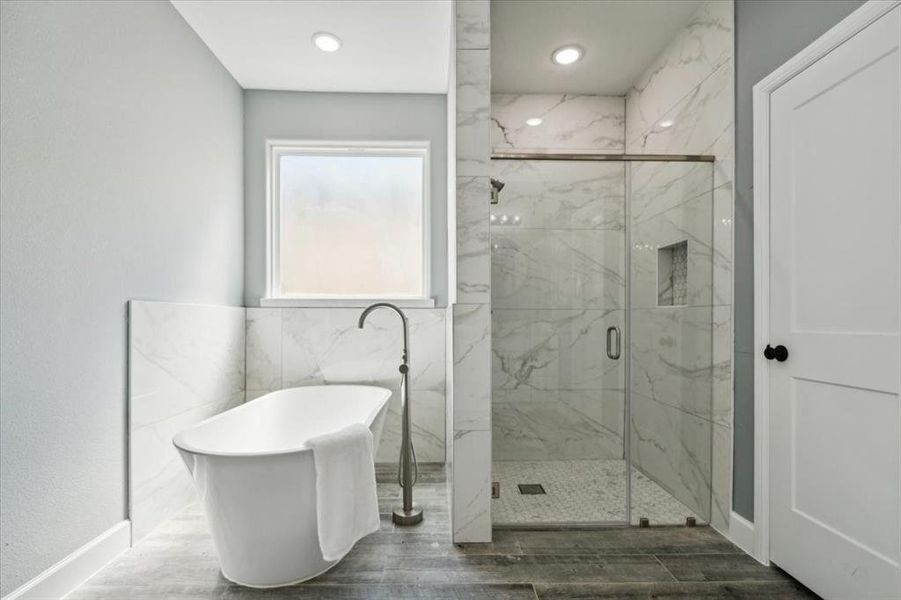 Bathroom featuring wood-type flooring and separate shower and tub