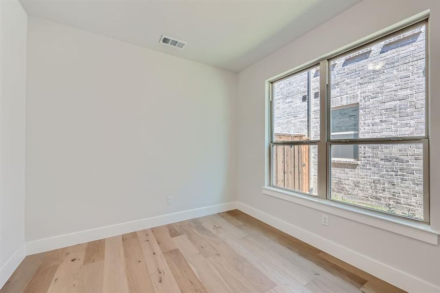 Unfurnished room with light hardwood / wood-style floors