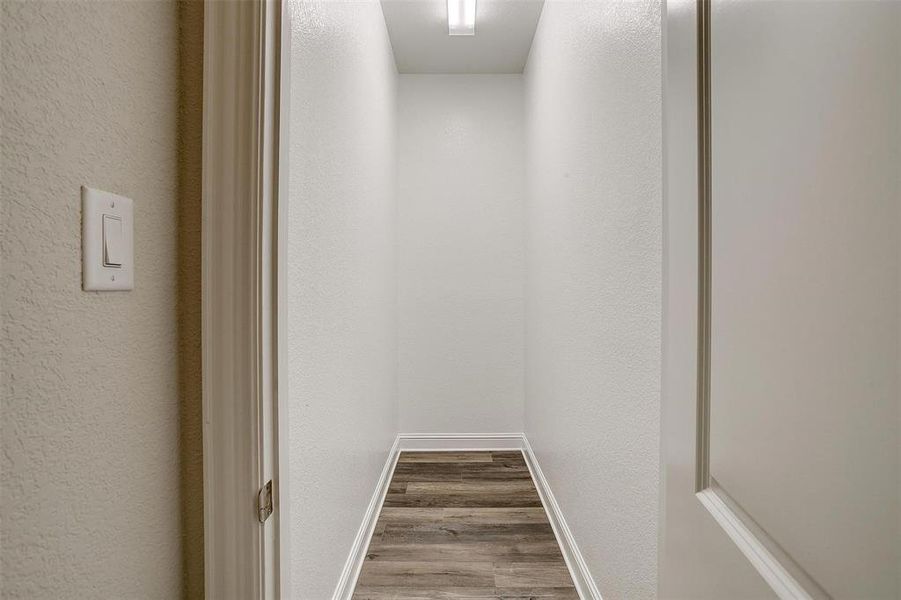 Hallway with wood-type flooring