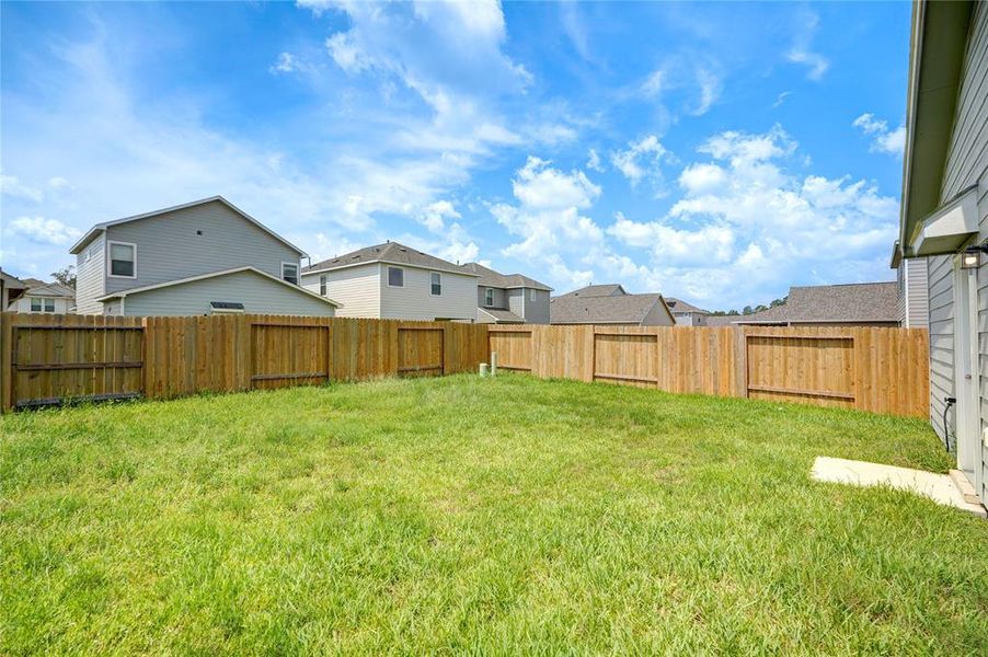 This backyard offers a serene outdoor retreat, perfect for relaxation and entertainment.