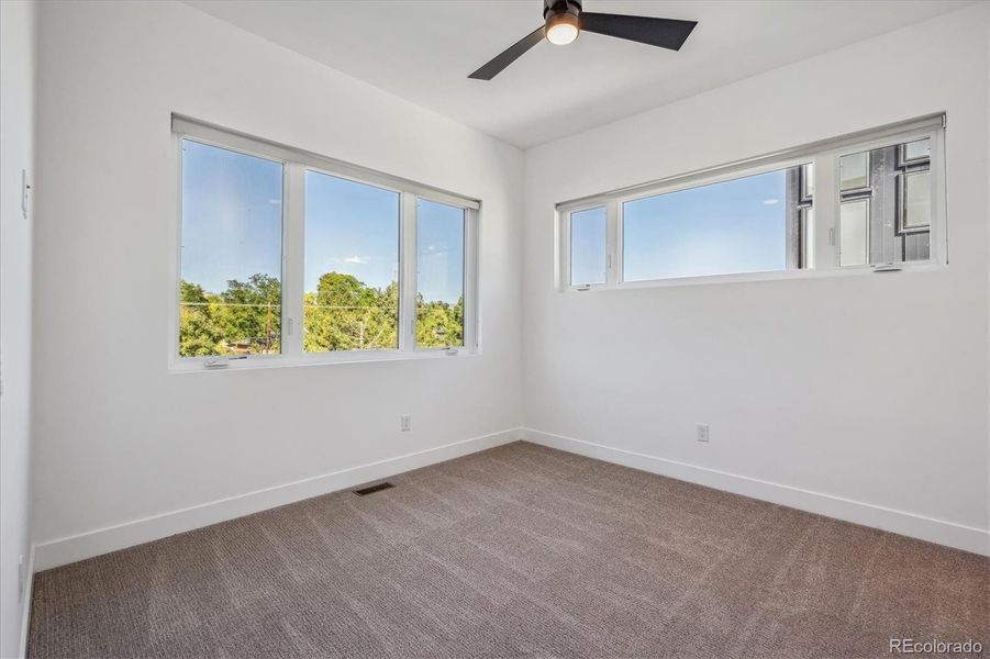 Upper-Level Secondary Bedroom. En-Suite Full Bathroom.