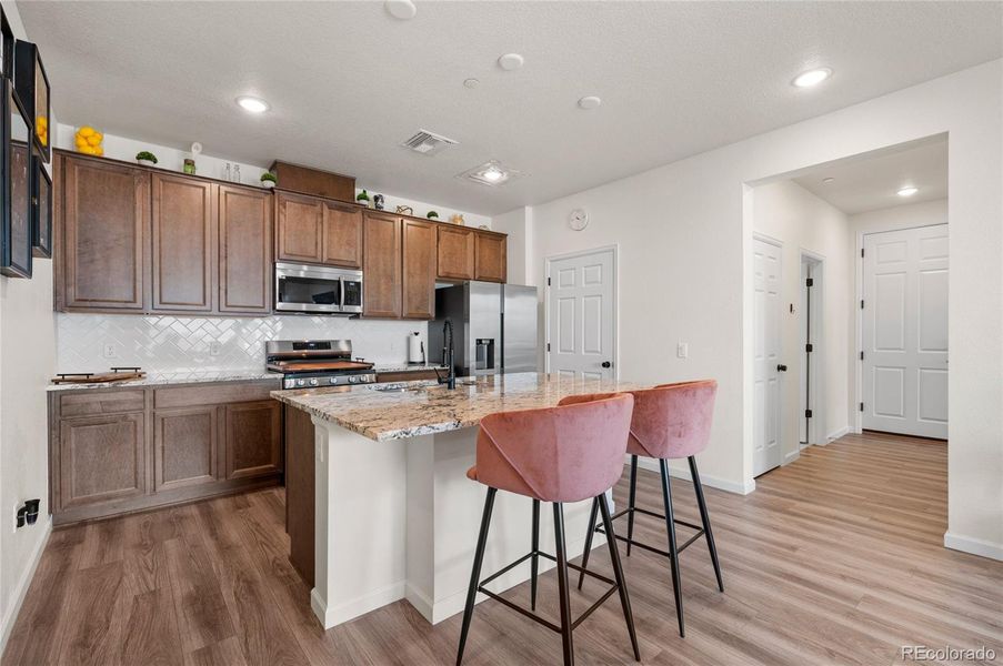 Beautiful kitchen with stainless steel appliances and a gas range.