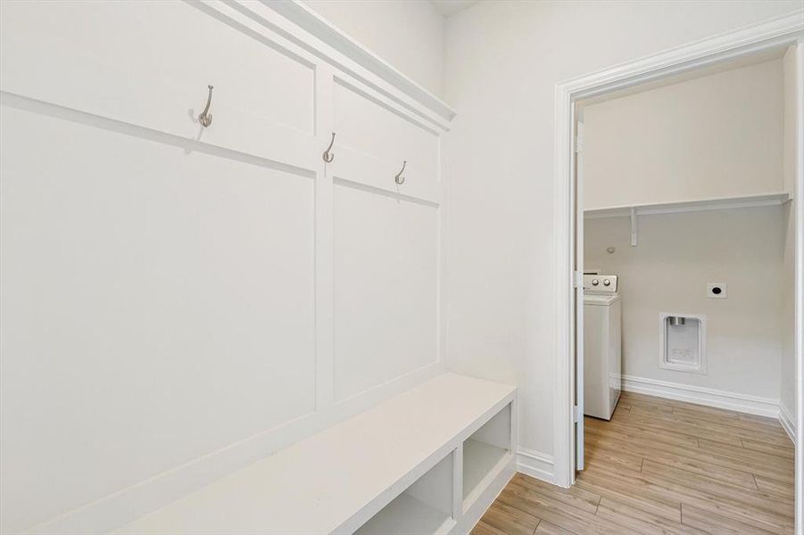 Mudroom featuring light hardwood / wood-style floors and washer / dryer