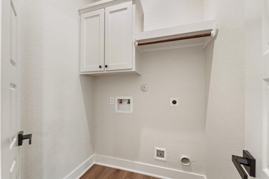 The laundry room with storage provides both electric and gas connections!