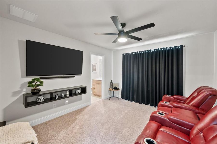 Living room with carpet flooring and ceiling fan