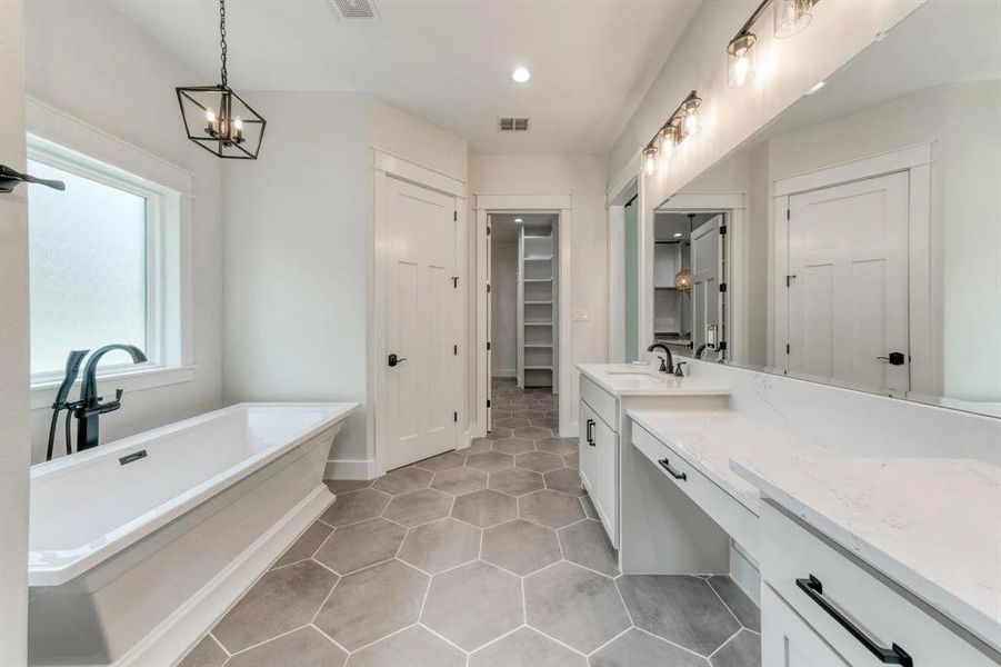 Bathroom with vanity, tile patterned flooring, a notable chandelier, and a bathing tub