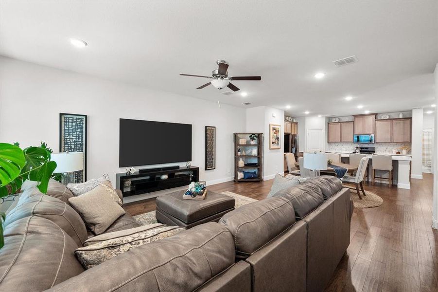 Living room featuring dark hardwood / wood-style flooring and ceiling fan