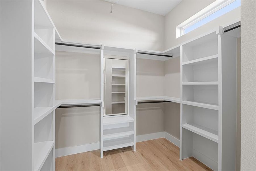 Spacious closet with light wood-type flooring