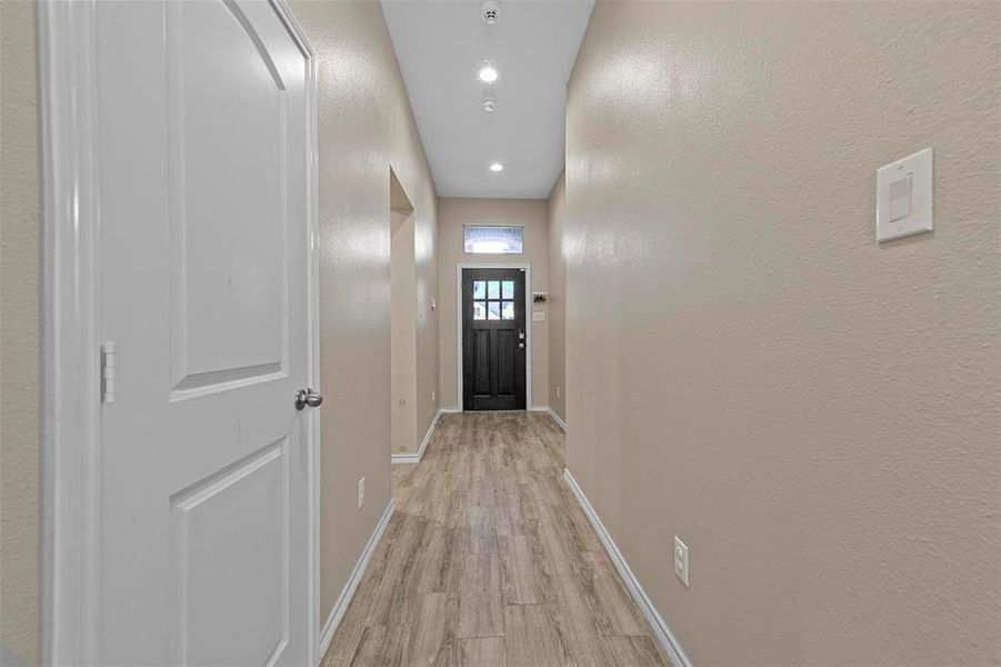 Doorway with light hardwood / wood-style flooring