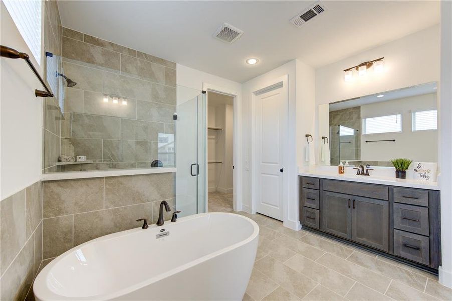 Elegant primary bathroom with standalone bathtub.