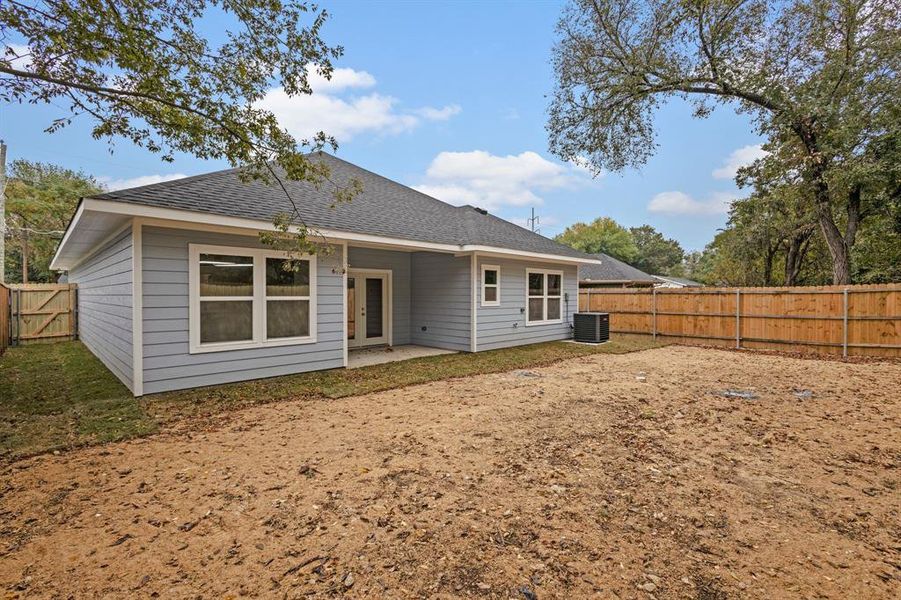 Rear view of house featuring a patio and cooling unit