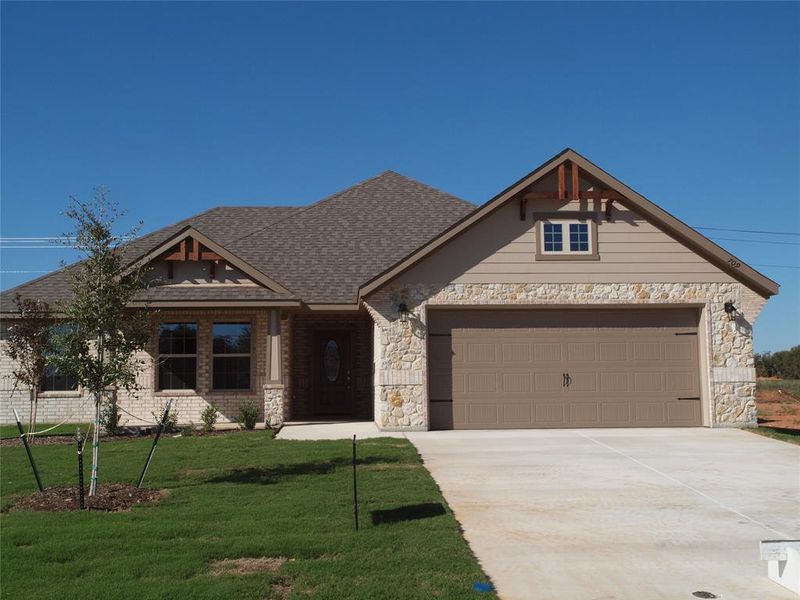 Craftsman-style house with a front yard and a garage