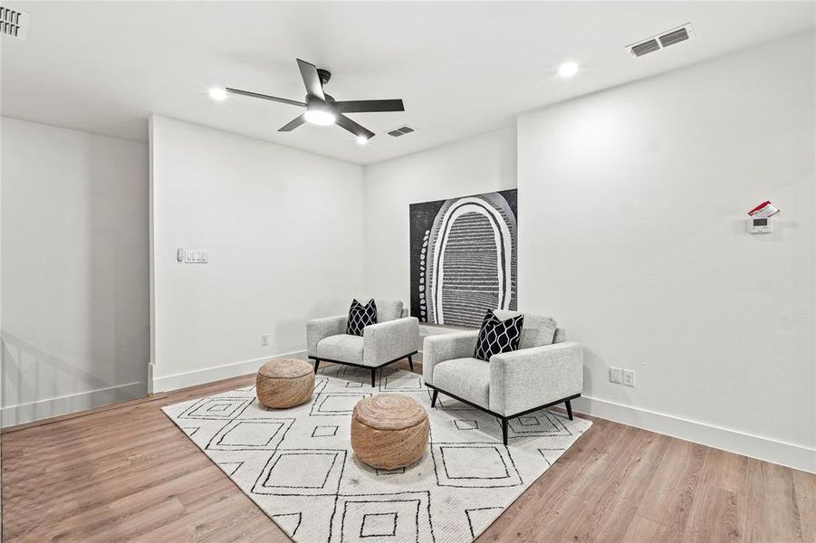 Office space with light hardwood / wood-style floors and ceiling fan