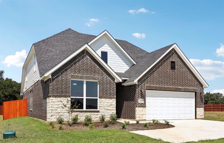 View of front of property with a garage and a front lawn