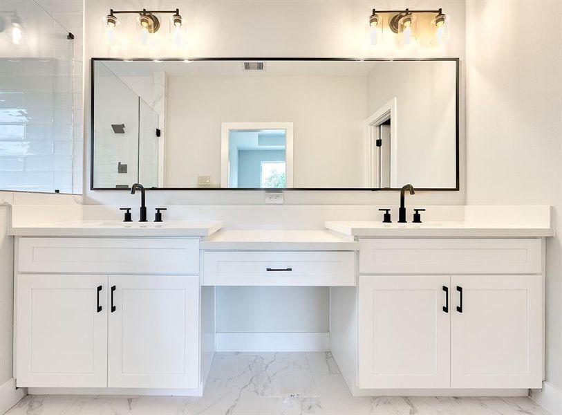 Master bathroom with wide counter space and large mirror.