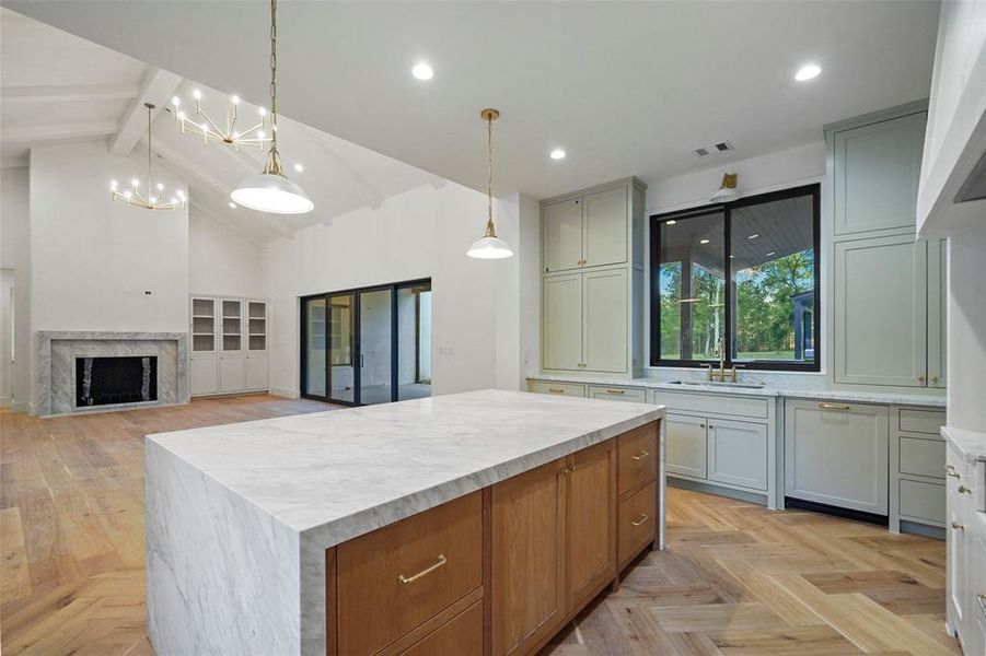 White oak island with plenty of storage and Calacatta waterfall countertop.